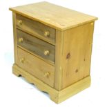 A modern pine chest of three graduating drawers with turned handles, 71 by 44.5 by 71.5cm high.