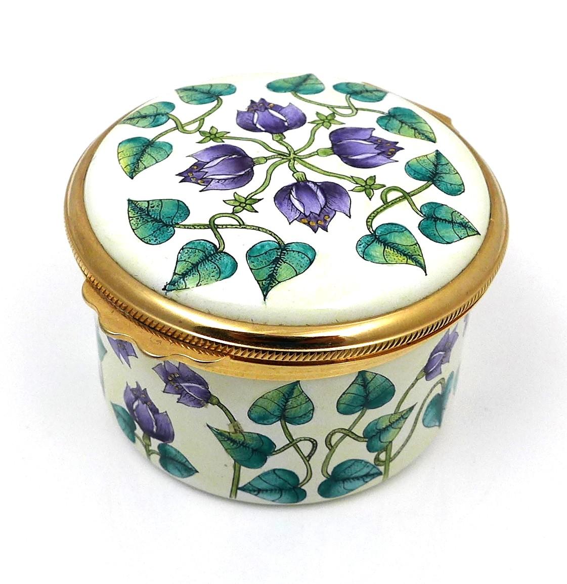 A modern Moorcroft enamel box clock, decorated with Florida Star pattern, of cylindrical form with