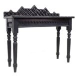 An unusual 19th century ebonised oak side table, the surface and upstand applied with moulding cut