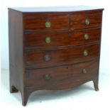 A Regency mahogany bowfronted chest of two short over three long graduating drawers, turned handles,