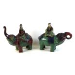A pair of Chinese Tang style figures, modelled as elephants each with a figure riding on it's