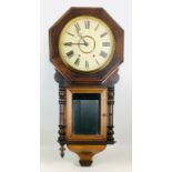 A Victorian mahogany wall clock, octagonal frame and turned decorative finials, with pendulum.
