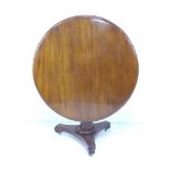 A Victorian mahogany tilt top centre table, circular surface with moulded edge, raised on a tapering