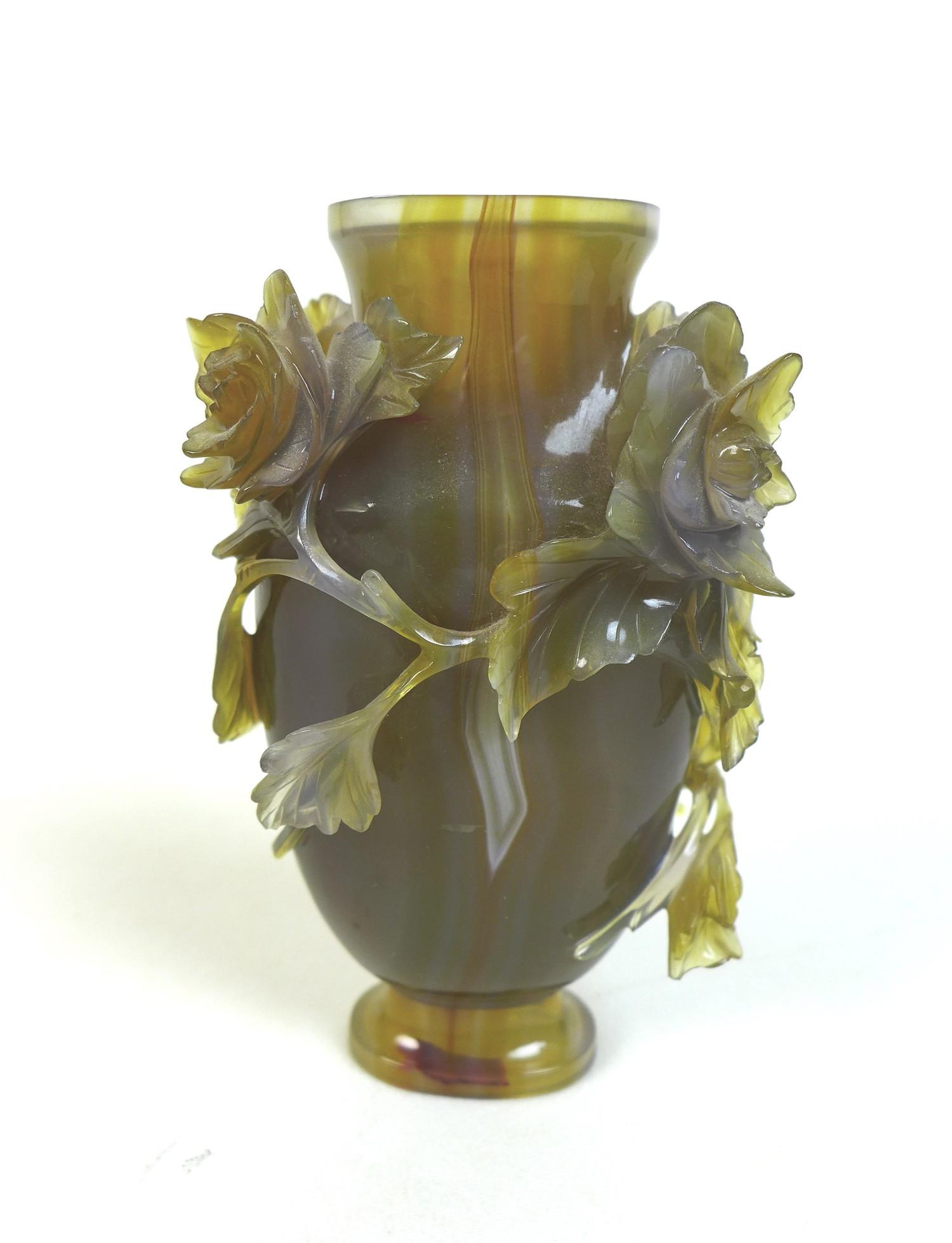 A Chinese agate vase, 19th century, intricately carved with chrysanthemums and trailing foliage.