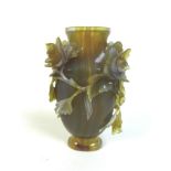 A Chinese agate vase, 19th century, intricately carved with chrysanthemums and trailing foliage.