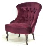 A Victorian nursing chair, bowed button back, serpentine front, upholstered in burgundy velvet,