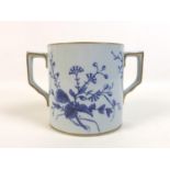 A 20th century Japanese blue and white twin handled tankard, with gilt decoration to rim and