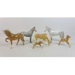 A group of Beswick horses, ponies and foals, comprising two Palamino horses with two foals family