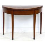 A George III card mahogany table, of demi lune form, line inlaid and crossbanded, dual kick leg
