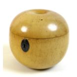 An early 19th century turned fruitwood tea caddy in the form of an apple, a/f missing stalk