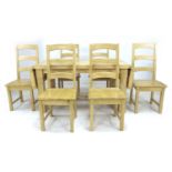 A modern beech dining table and six chairs, rectangular surface with drop leaves, square section