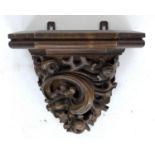 A carved wooden wall bracket, early 20th century, carved in high relief with foliate scrolling