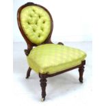 A Victorian mahogany spoon back nursing chair, with floral carved and moulded frame, upholstered