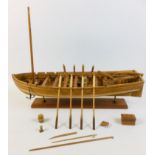 A scratch built wooden model of a large sailing rowboat, with provision for up to sixteen oars,