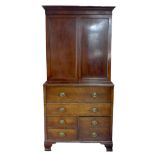 A George III mahogany bookcase, twin door enclosing shelves, secretaire drawer over one wide, one