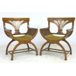 A pair of Biedermeier mahogany armchairs, with stylised wheatsheaf splats, bowed seats, slatted