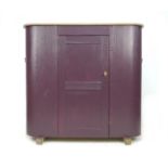 A French 19th century pine larder cupboard, of D section, later painted an aubergine colour, with