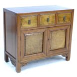 A Chinese hardwood cabinet, early to mid 20th century, with three frieze drawers with veneered