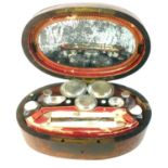 A French burr walnut Gentleman's dressing case, circa 1810, of oval form with four fitted lift out