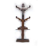 A Victorian mahogany hall stand, the shaped upright with four arms and eight turned pegs, glove