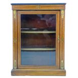 A 19th century walnut pier cabinet, possibly French, the single glazed doors enclosing two