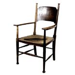 An Arts and Crafts oak open arm nursing chair, of Glasgow School influence, with rush seat and