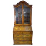 A Dutch 19th century marquetry bureau bookcase, with arched moulded cornice above twin glazed