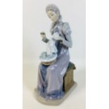 A Lladro 'Seamstress' figurine, 11 by 14.5 by 28.5cm high.
