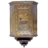 A Continental early 19th century mahogany corner cupboard, single flat fronted door to canted