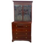 A George III mahogany secretaire bookcase, the twin astragal glazed doors enclosing three shelves,