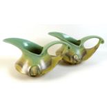 A pair of Dutch Art Deco jugs of squat curvilinear design with slip glaze in pale green, buff and