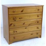 A modern pine chest of five drawers with turned handles, 96 by 51 by 90cm high.