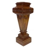 A reproduction Victorian style mahogany pedestal, with carved decoration, and of stepped and