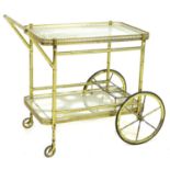 A vintage Italian bamboo effect cocktail drinks trolley, with two glass shelves, pierced galleries,