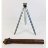 An early to mid 20th century French telescopic tripod, each of the three legs with five slides,