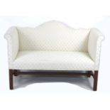 A modern Georgian style two seater settee, with straight back and upright arms, channelled legs