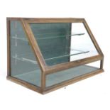 A glazed table top shop display case, early 20th century, mahogany frame with sloped glazed front