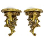 A pair of modern reproduction Rococo style wall brackets, with demi lune surfaces and scroll form