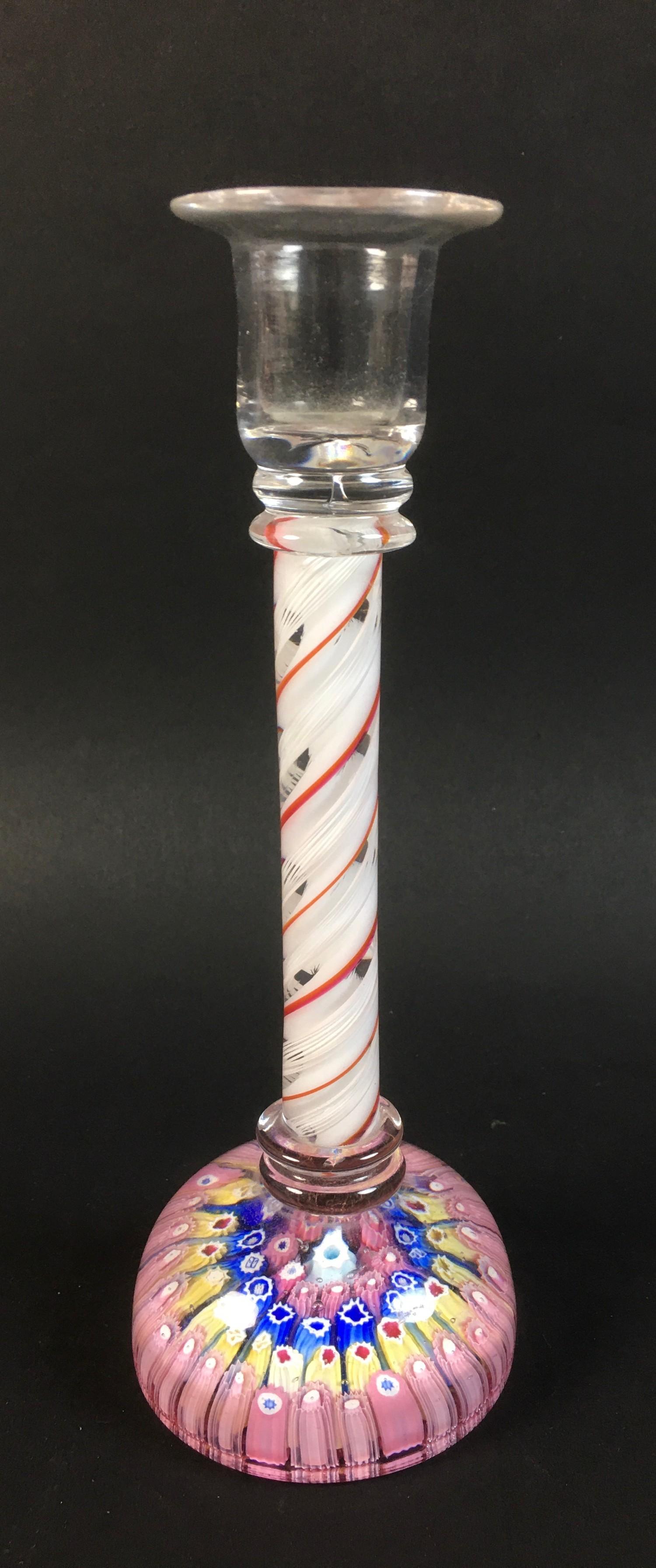 A glass candlestick with candy twist stem in white red and clear glass and millefiore paperweight