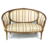 A French two seater settee, mid 20th century in Louis XVI style, with curved back with integral