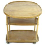 An Ercol elm and beech tea trolley, circa 1970, with drop leaves and three tiers, ball castors,