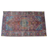 A hand knotted wool Hamadan rug, with mulit coloured central medallion and profuse floral patterns