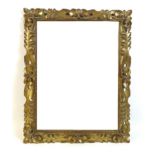 A Continental giltwood framed mirror, circa 1940, carved with foliate scrolling decoration,