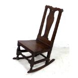 A Georgian nursing or rocking chair, likely early to mid 18th century, with shaped back, 46 by 61 by