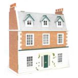 A late 20th century town house style dolls house with basement and dolls house furniture