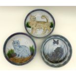 A group of Highland Stoneware pottery, comprising three large bowls each depicting cats, two signed,
