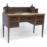 An Edwardian mahogany, line inlaid and crossbanded desk, upstand with two trinket drawers over a