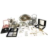 A collection of silver plated items, including three spirit labels, a spirit kettle on stand,