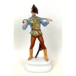 A Herend figurine of a Hungarian dragoon, numbered 5526 and signed 'S' to its base, 10 by 6 by