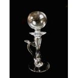A 19th century clear glass lace maker's oil lamp, with spherical holed top above a drip pan, above a